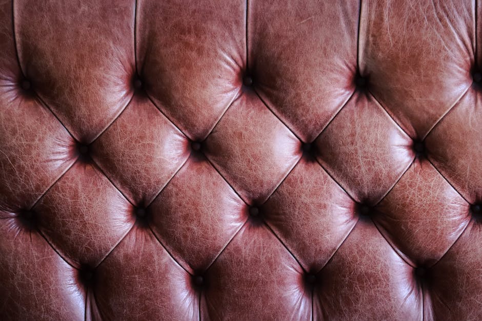 Close-up of tufted brown leather upholstery showcasing a vintage texture.